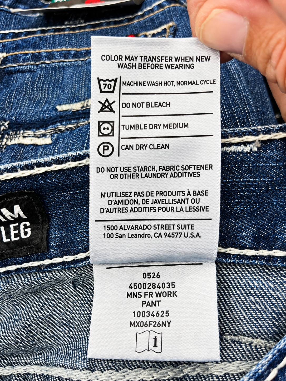 Ariat FR jeans washing instructions showing machine wash hot, no bleach, tumble dry medium, dry cleaning permitted, and no fabric softener or starch.